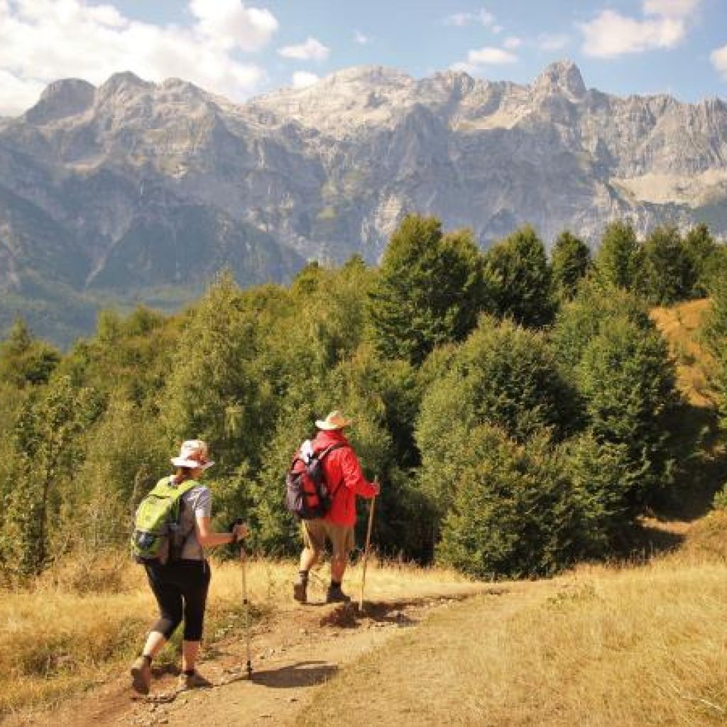 Trekking the Valbona to Theth trail in the Albanian Alps, highlighting the popular outdoor activities in Albania.